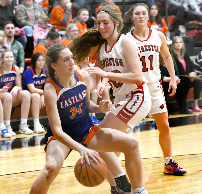 Eastland's Trixie Carroll (34) makes a move to th basket as Forreston's Jenna Greenfield defends during a NUIC game on Friday, Feb. 3 in Forreston.
