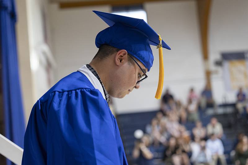 Newman salutatorian Jedh Valida leaves the stage after accepting his award Wednesday, May 15, 2024 during commencement.