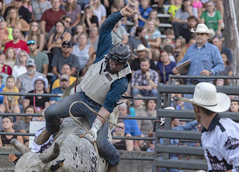 Jeffrey Ciolkosz hangs on in his ride during the Rice Bull Riding and Barrel Racing event Thursday, August 11, 2023 at the Carroll County fair.