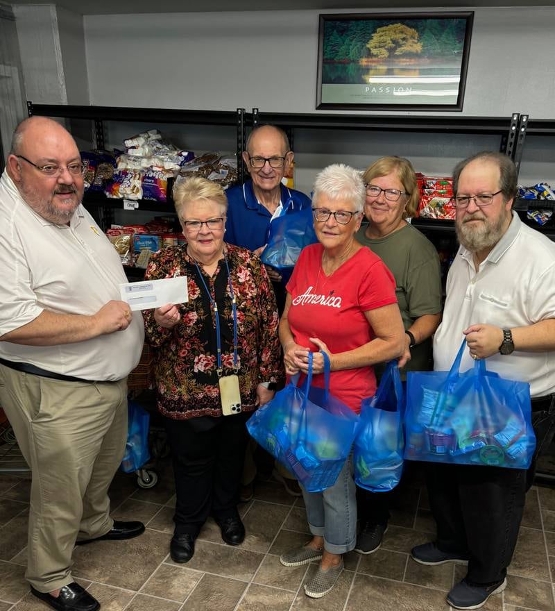 (From left) Sam Sankovich, Jan Martin, Ken Ficek, Molly Thrasher, Bev Kimble and Gary Ferrari gather for a $500 donations from the Oglesby Elks Club to the Hall Township Food Pantry. The blue bags they are holding are “Food for Kids” bags that are given to families with children. These highly prized bags are filled with kid-friendly foods and bring great joy to youngsters each visit.