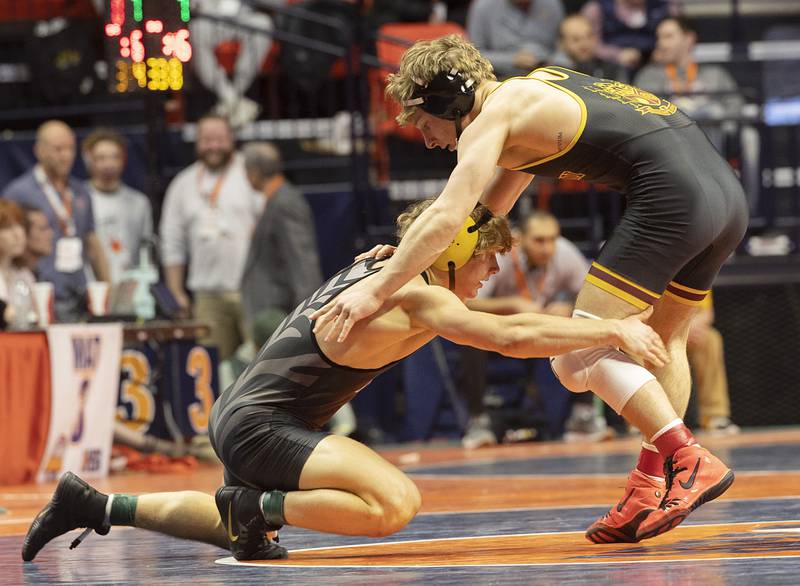 Evan Willock of Normal West takes a shot against Montini’s Harrison Konder in the 157 pound third place 2A match Saturday, Feb. 17, 2024 at the IHSA state wrestling finals at the State Farm Center in Champaign.