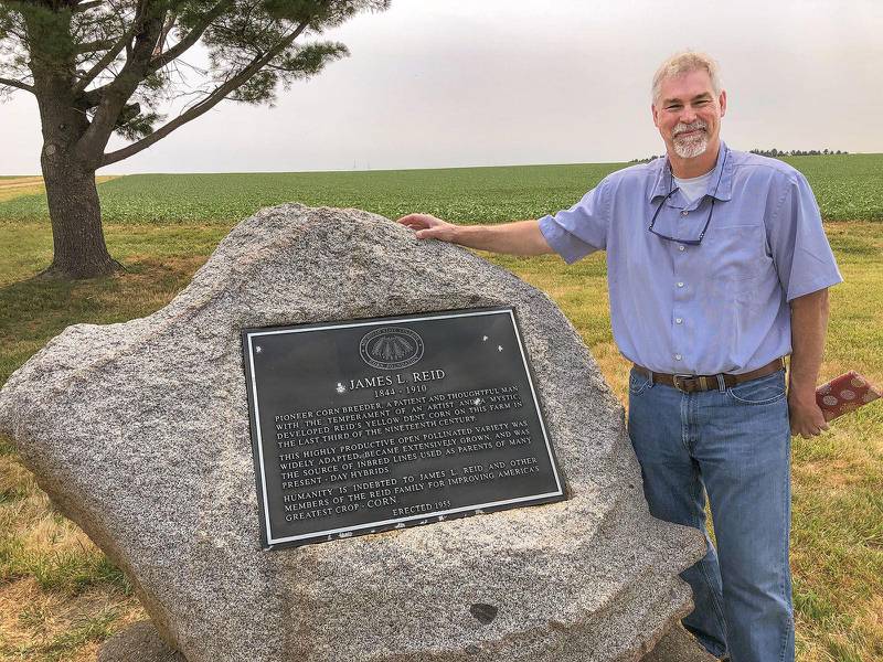 Matt Shipton, a seed industry representative and descendant of Robert and James Reid, stands by a historical marker at the Tazewell County farm where the Reids developed Reid’s Yellow Dent Corn in the 1800s.