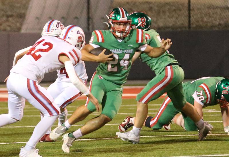 L-P's Easton Moriarity carries the ball as Ottawa's Joey Liebhart gets ready to make the tackle on Friday, Sept. 13, 2024 at Howard Fellows Stadium.