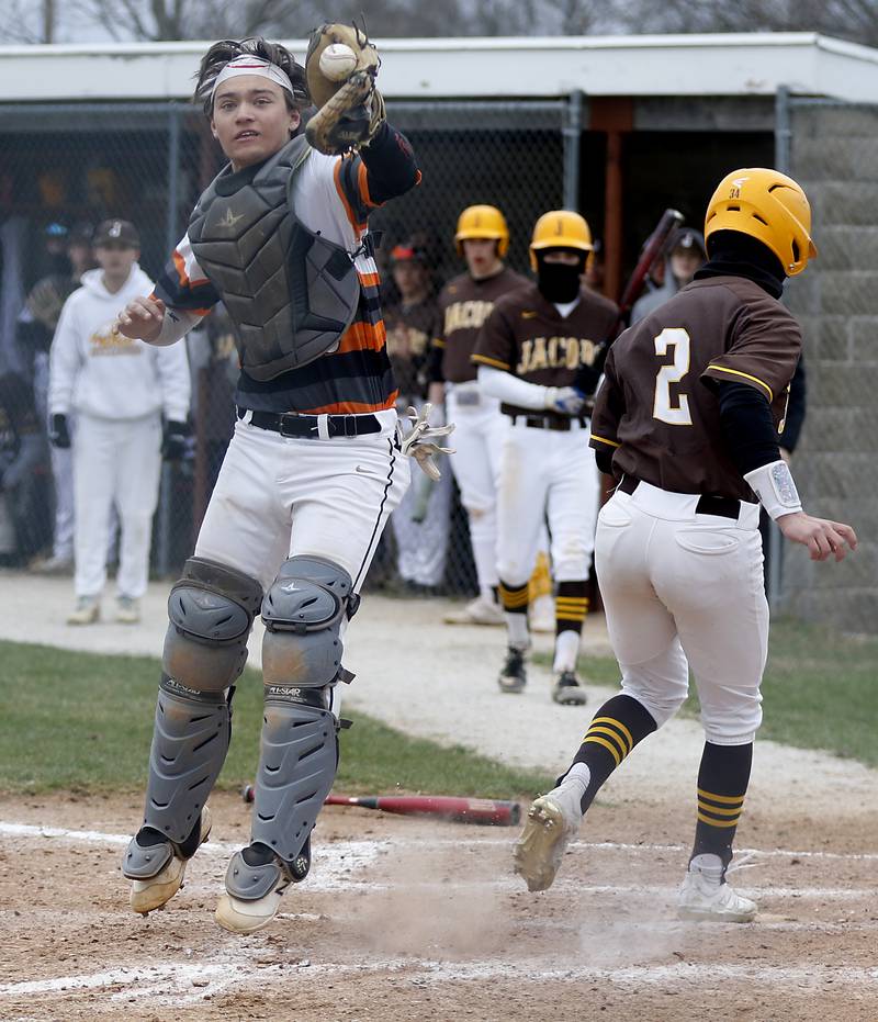 McHenry's Cooper Cohn fielded the throw as Jacobs's Nick Gottfried scores a run during a Fox Valley Conference baseball game Friday, April 15, 2022, between Jacobs and McHenry at Petersen Park in McHenry.