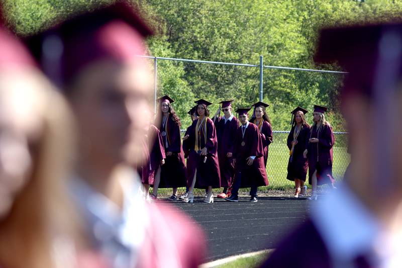 Members of the Prairie Ridge High School Class of 2024 march to commencement at the school in Crystal Lake on Saturday.