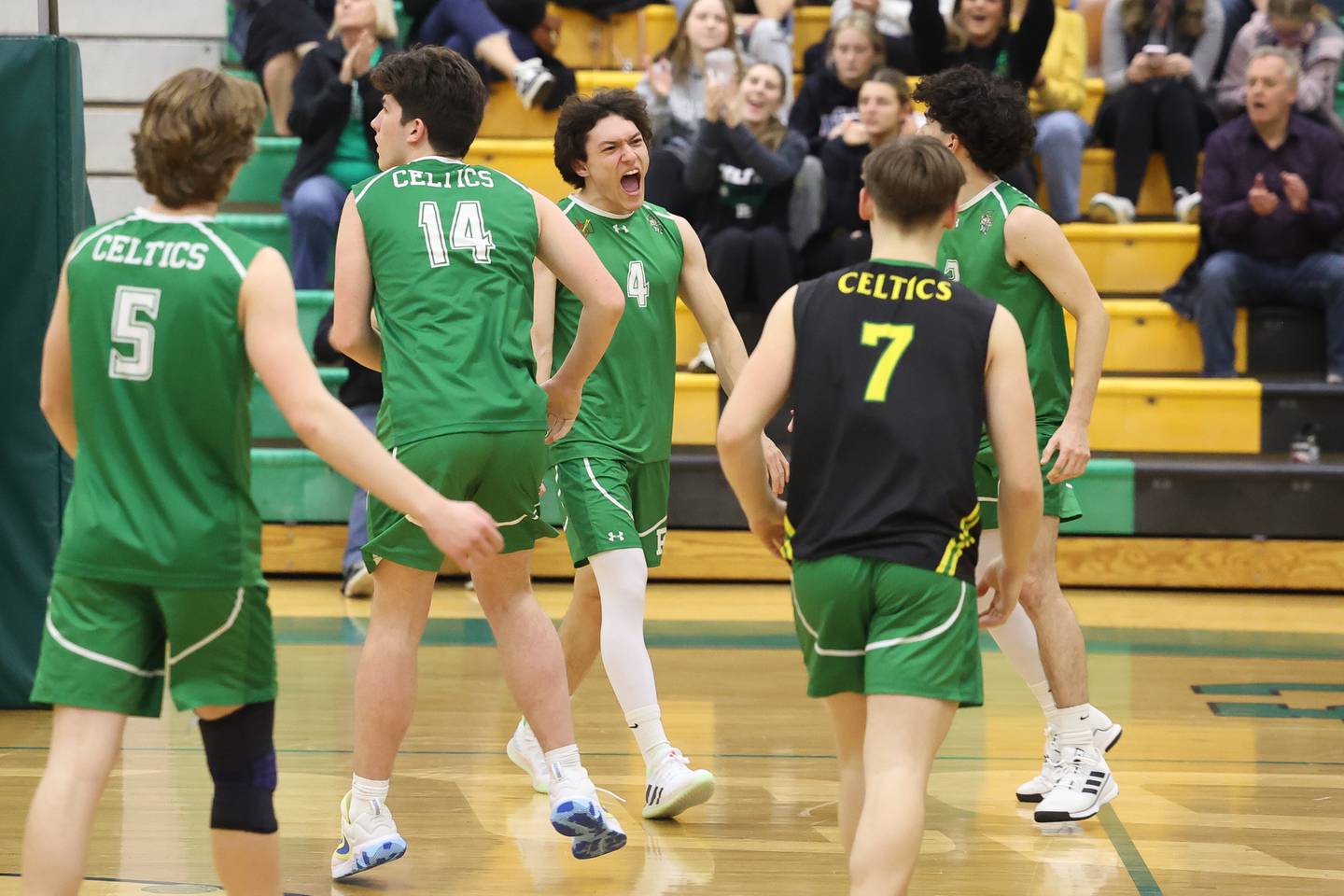 Providence’s Christo Krabbe, center, celebrates match point against Joliet Catholic on Monday, March 25, 2024 in New Lenox.