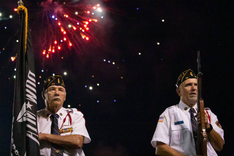 Veterans from Ottawa’s American Legion Present the Colors with firework display in background on Thursday, July 4, 2024 at Ottawa High School.