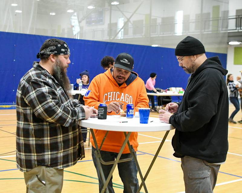 (From left) Christopher Heinze, of Sycamore, Richard Vela, of Bartlett and Michael Horton, of Sycamore, taste test chili during the chili cook-off and rank their favorites during the Sycamore Park District's Fire and Ice Festival held at Sycamore Park District Community Center on Saturday, Jan. 13, 2024.
