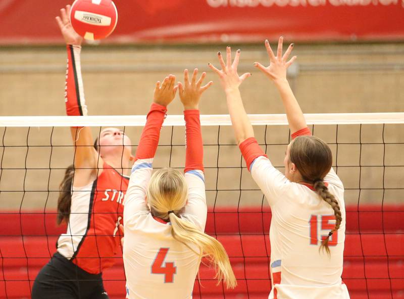 Streator's Aubrey Jacobs spikes the ball past Ottawa's Ella Schmitz and teammate Addison Duggan on Thursday, Aug. 29, 2024 in Kingman Gym at Ottawa High School.