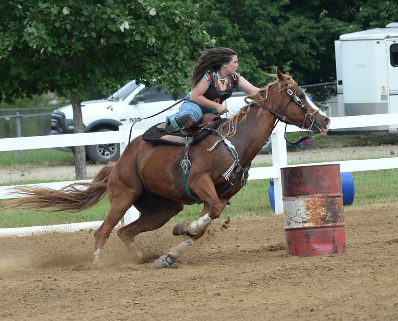 Brynli Dotson, 14, of Washington, Illinois, clears a barrel with her horse Duke in the 18-under barrel racing competition at the WHOA benefit horse show on Saturday, June 22, 2024, at the Whiteside County fairgrounds in Morrison.