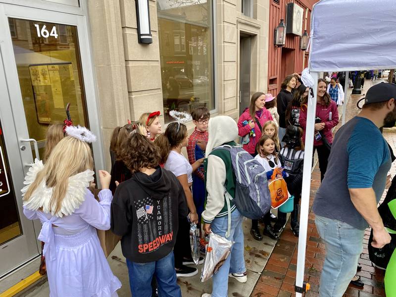 Costume-clad families took downtown DeKalb by storm Thursday, Oct. 26, 2023 for the 26th annual Spooktacular trick-or-treating event hosted by the DeKalb Chamber of Commerce. Here, children gather outside the candy booth hosted by the city of DeKalb outside DeKalb City Hall, 164 E. Lincoln Highway, DeKalb.