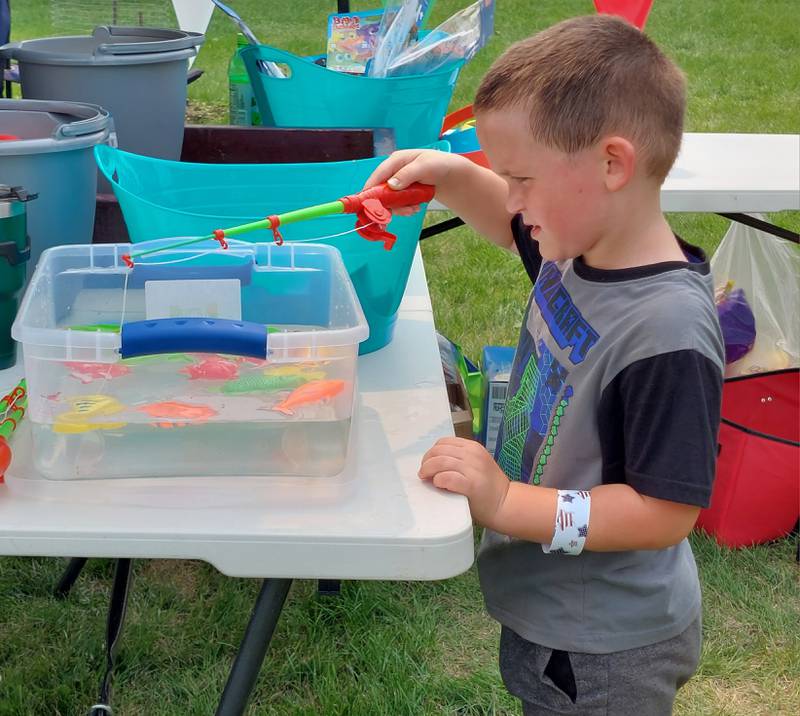 Trenton Guest, of Farmer City, plays the fishing game Sunday, July 16, 2023, during the Long Point Sesquicentennial celebration. The celebration took place over three days and included a Saturday night fireworks show.