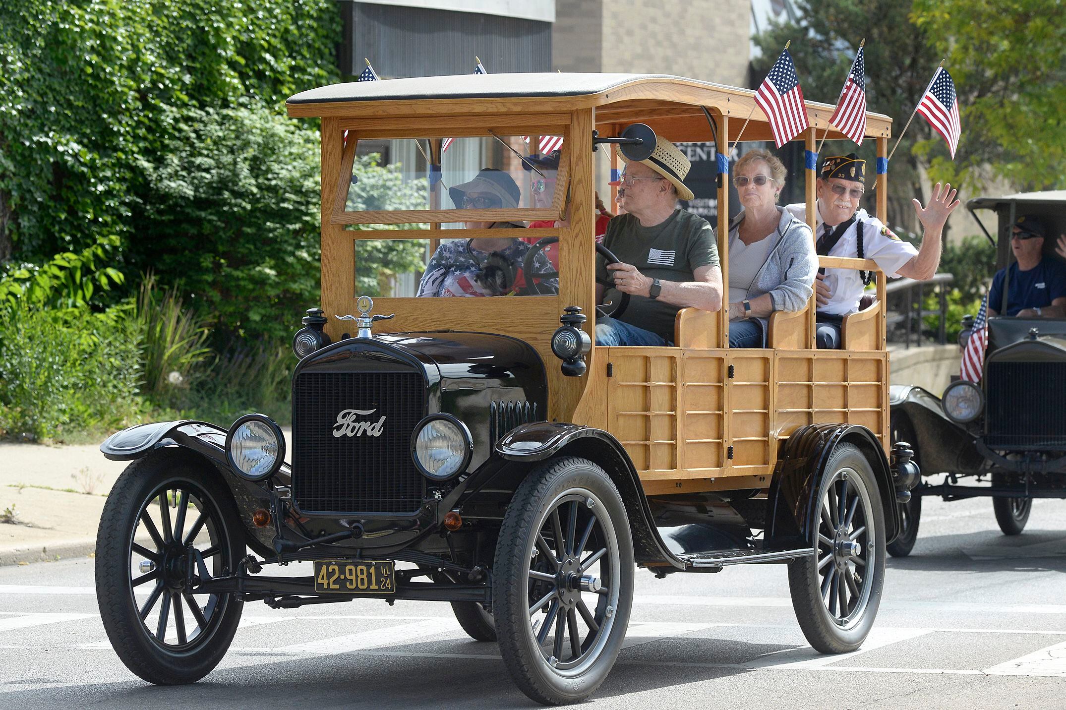 Local veterans wave to those along the Memorial Day parade route Monday, May 29, 2023, in Ottawa prior to the ceremony at Washington Square.