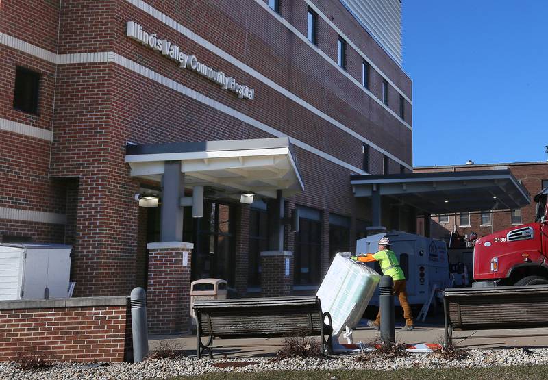 A worker pushes insulation into the Emergency Room entrance of the former IVCH and St. Margaret's Hospital on Tuesday, Feb. 20, 2024 in Peru. OSF Healthcare is renovating the building and is planning on re-opening the hospital on Sunday April 7.