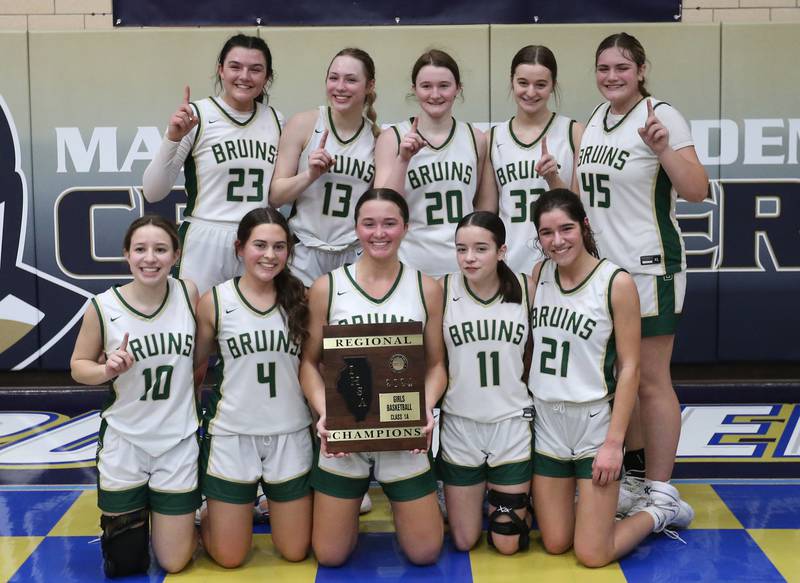 Members of the St. Bede girls basketball team pose with the Class 1A Regional plaque after defeating Amboy on Friday, Feb. 16, 2024 at Marquette High School.