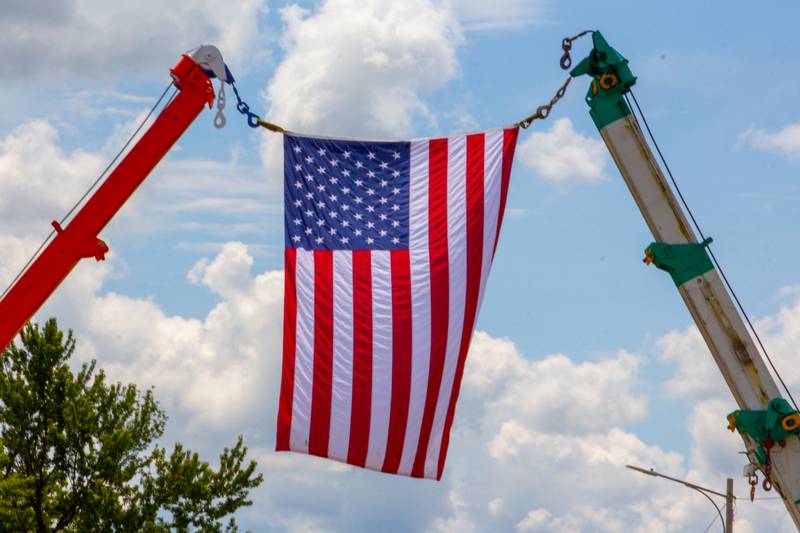 American flag hangs above the Convoy Against Cancer Big Truck Show on Saturday, July 20, 2024 on Main Avenue in Ladd.