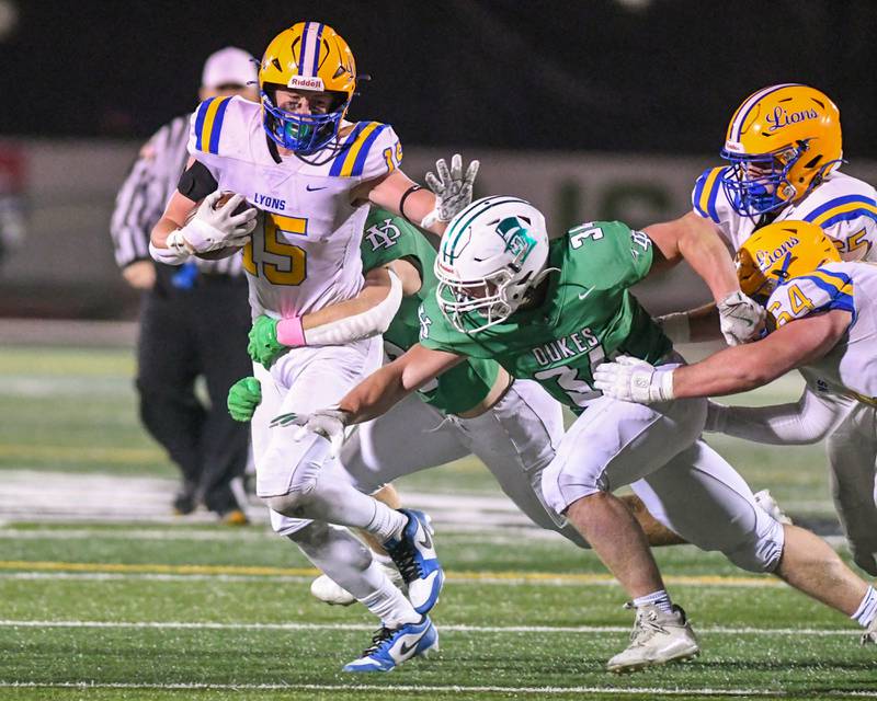 Lyons Township's Tucker King (15) runs the ball before being brought down by York High School Jimmy Conners on Friday Oct. 18, 2024, held at York High School in Elmhurst.