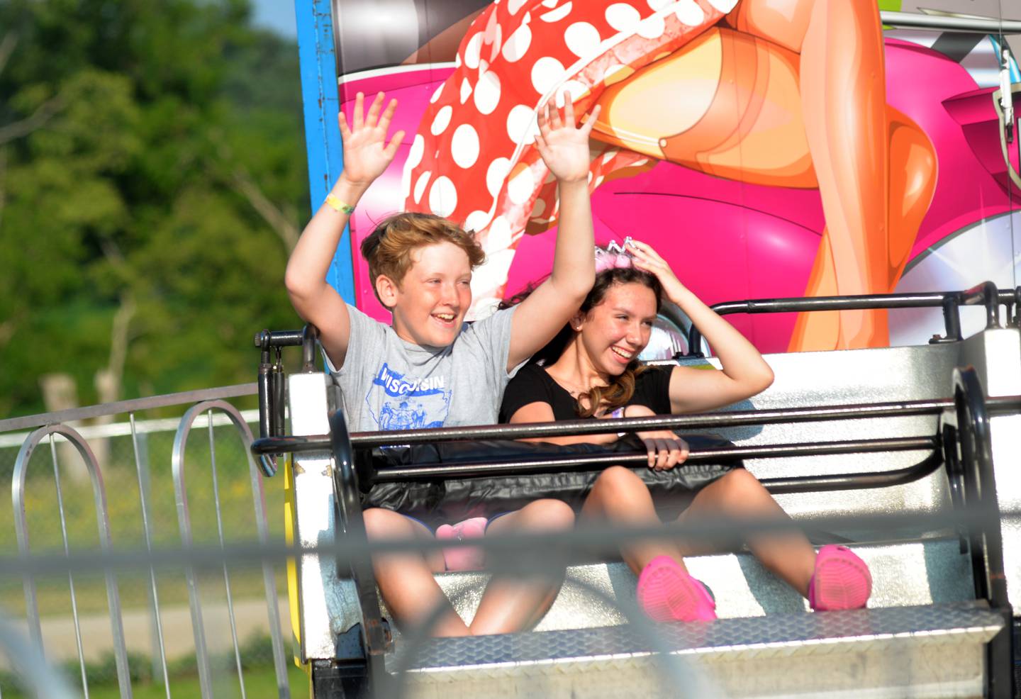 Jonithan McCullough, 12, and Evelyn Simpson, 13, both of Stillman Valley, take a spin on one of the carnival rides at the Ogle County Fair on Saturday, Aug. 5, 2023.