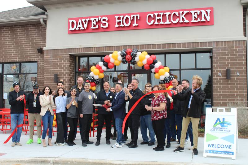 Co-owner Rocco Armocida cuts the ribbon of the new Dave's Hot Chicken in Algonquin on Friday, Nov. 3, 2023.