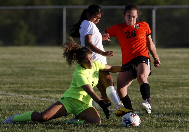 Boylan's Natalya Razo tries to grab the ball as Crystal Lake Central's Jillian Mueller tries to take a shot on goal while being defended by Boylan’s Mary Therese Harrison during the IHSA Class 2A Burlington Central Girls Soccer Sectional final match Friday, May 26, 2023, at Burlington Central High School.