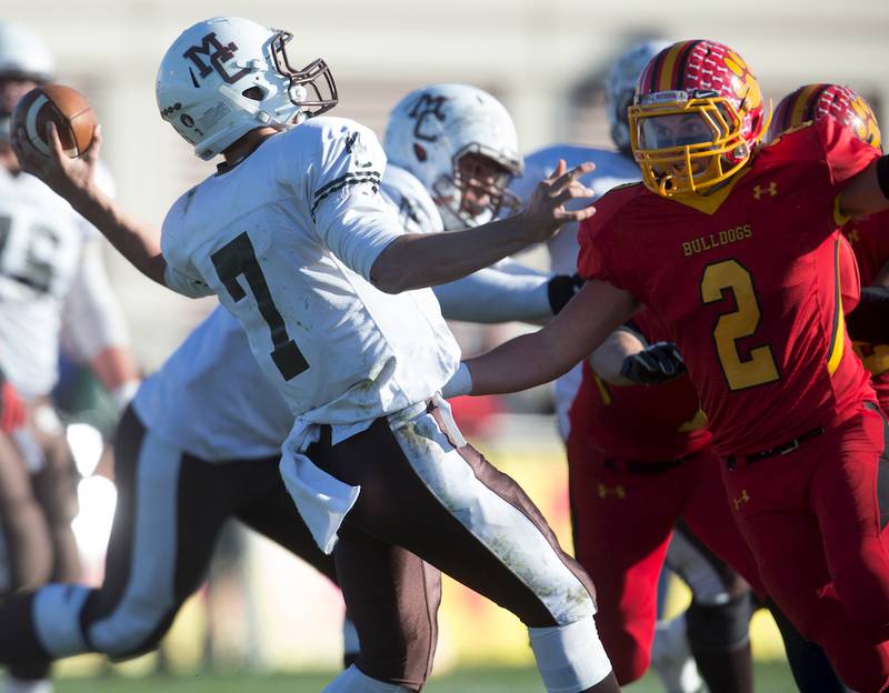 Batavia linebacker Colin Thurston closes in on Mt. Carmel quarterback Anthony Thompson on Saturday in Batavia. The Caravan won the 7A playoff game, 21-16.