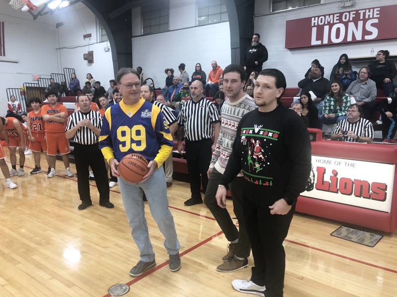 Brian Blumhorst (from left), father of DePue coach Trae Blumhorst and LaMoille coach Chance Blumhorst prepares to toss a ceremonial jump before Friday's game in LaMoille.