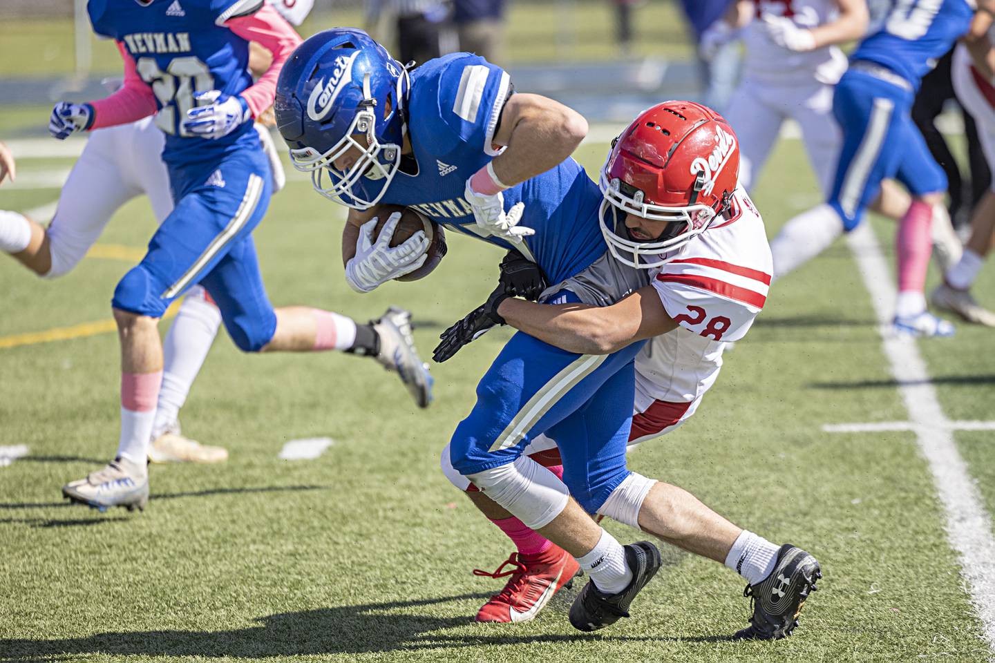 Newman’s Carter Rude fights for yards against Hall’s Deanthony Weatherspoon Saturday, Oct. 7, 2023 in a game in Sterling.