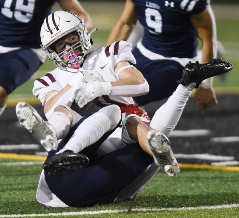 Joe Lewnard/jlewnard@dailyherald.com
Wheaton Academy’s Zachary Moravec gets tackled by St. Viator’s Montay Washington during Friday’s Class 4A football playoff game in Arlington Heights Friday.