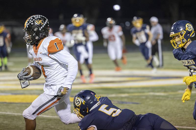 United Township’s Korey Randle picks up yards in the first half against Sterling Friday, Oct. 21, 2022.