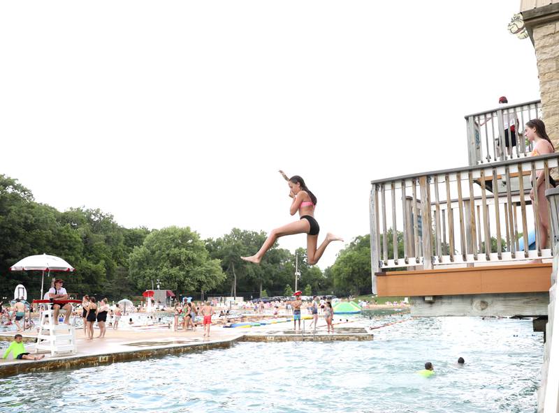 Lyla Mikoda, 12, jumps off the diving platform at the Batavia Park District’s Hall Quarry Beach on Thursday, June 13, 2024.