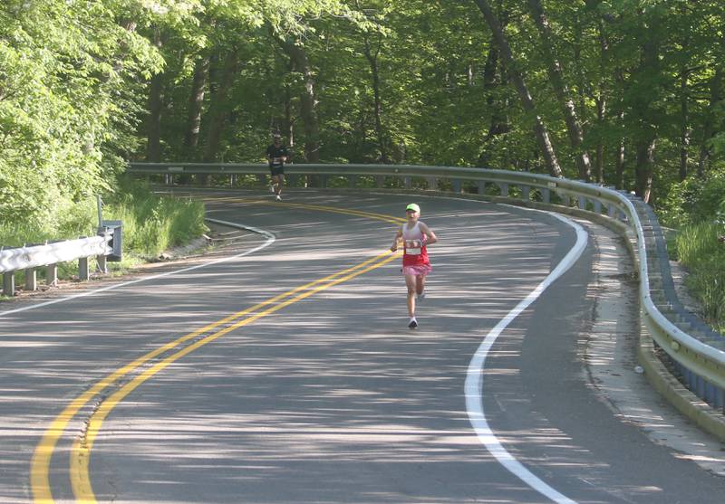 Runners jog down a portion of Illinois Route 71 during the Starved Rock Marathon and Half Marathon on Saturday, May 11, 2024 at Starved Rock State Park.