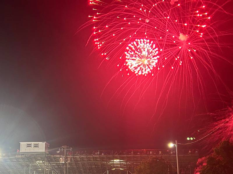 Fireworks go off above the Grundy County Speedway grandstands.