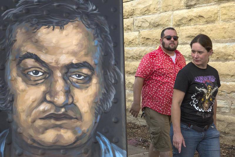 Jonathan and Danielle Meyer check out a portrait of Elwood Blues during last year's Prison Break-In at the Old Joliet Prison.