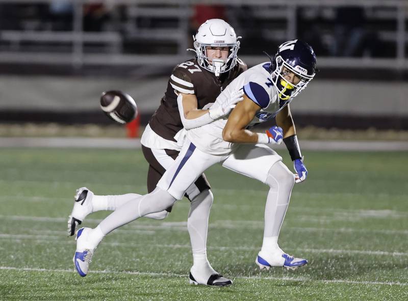 Nazareth's Jake Cestone (7) attempts a catch while Mt. Carmel's Zander Gorman (27) defends the play during the varsity football game between Nazareth Academy and Mt. Carmel high school on Friday, Sep. 13, 2024 in Chicago.