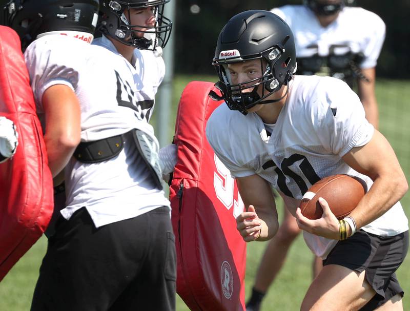 Sycamore quarterback Burke Gautcher carries the ball Monday, July 15, 2024, during summer football camp at Sycamore High School.