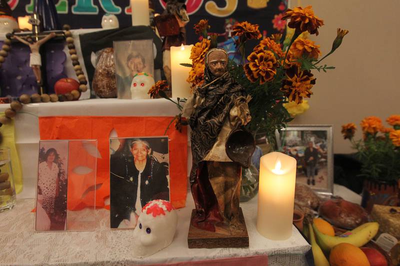 In this file photo, an altar honors loved ones who have passed away with photos, candles and flowers. It was on display during a 2022 Day of the Dead Celebration at the Round Lake Beach Cultural & Civic Center.