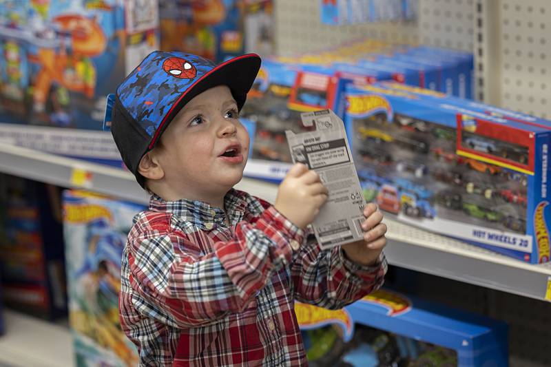 Grayson Gordon, 2, excitedly holds up a toy car while shopping at Walmart during Dixon’s Shop with a Cop. Dixon, Lee County and Amboy departments participated in the yearly tradition.