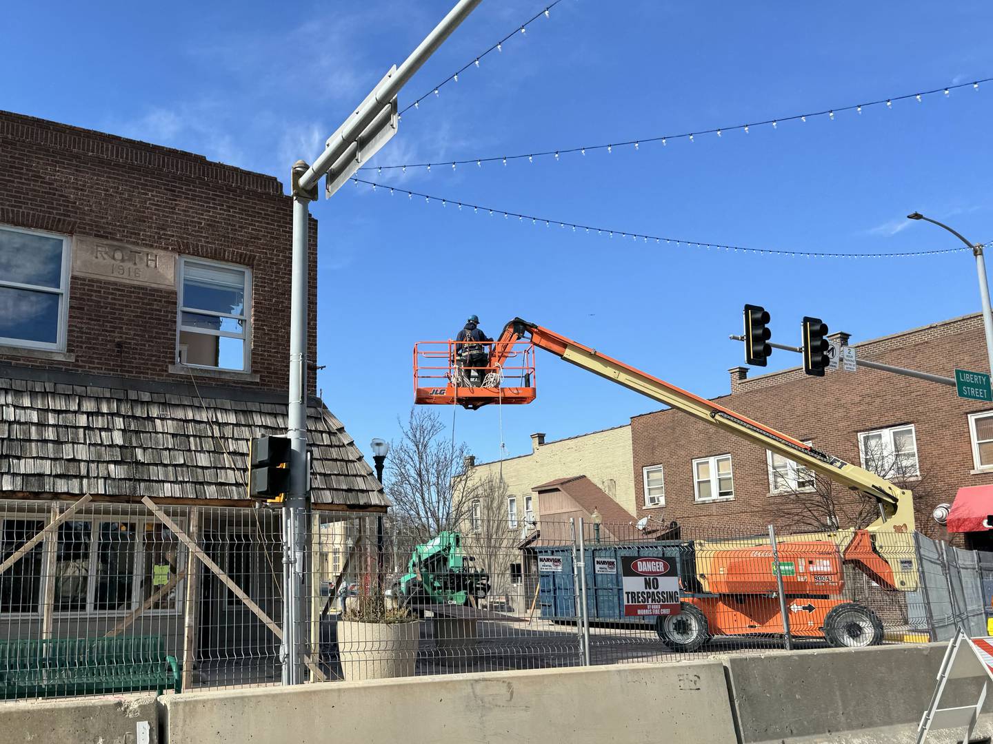 Construction workers conduct the demolition of 322 Liberty St. during the day on Friday, Feb. 9.