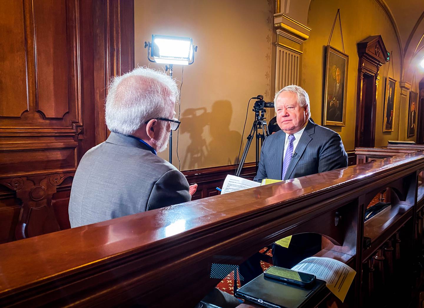 Jak Tichenor (left), host of “Illinois Lawmakers” talks with House Assistant Majority Leader Jay Hoffman, D-Swansea, about a recent memo from the governor’s office to agency directors asking them to identify $800 million in budget cuts. The episode of Illinois lawmakers will be available at capitolnewsillinois.com on Friday, May 10.