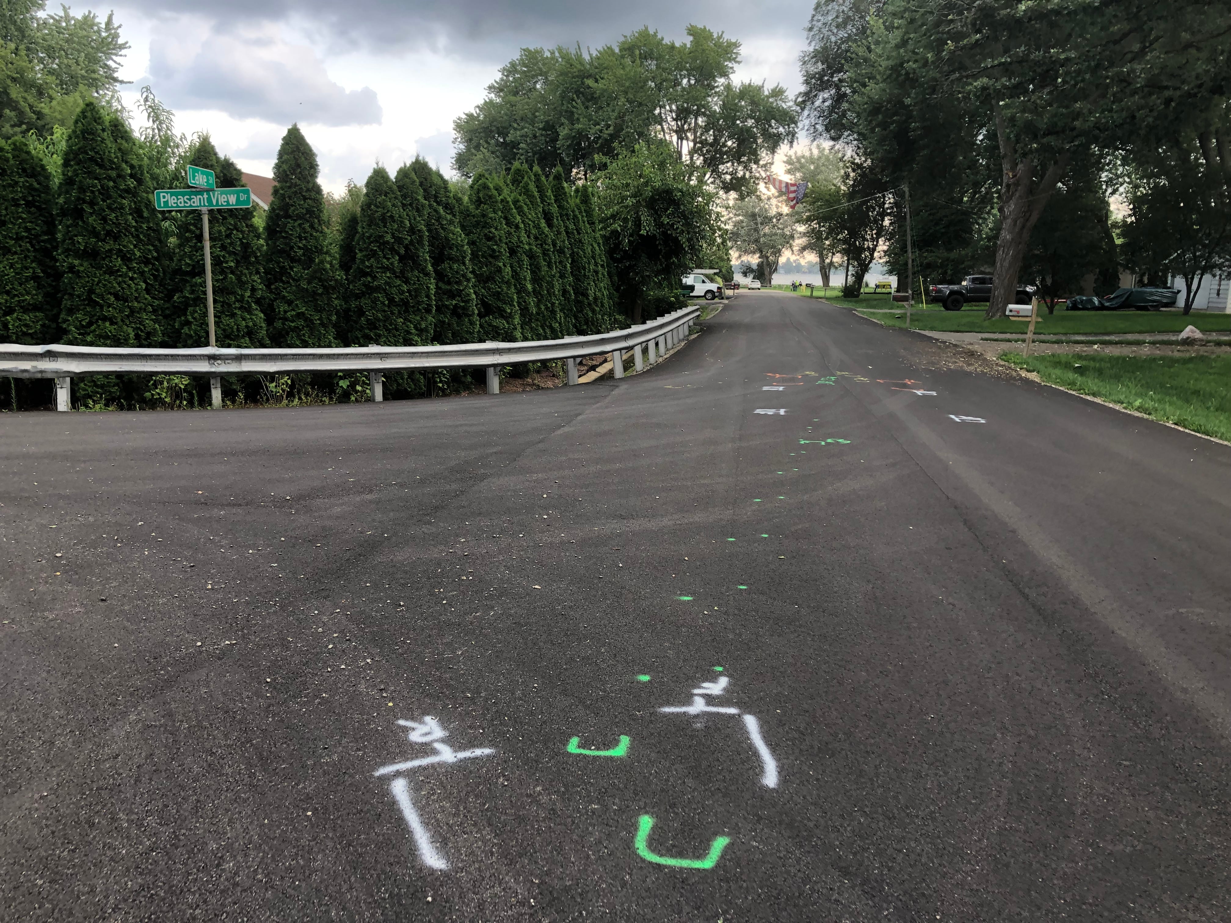 Paint markings remain on the street in the Johnsburg area on Friday, Aug. 2, 2024, where days earlier a boy was hit by a car while riding an electric mini-motorbike.