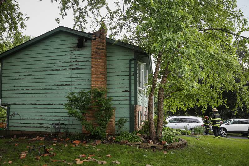 Damage to siding and the home's chimney is seen following a lightning strike and fire Monday, June 13, 2022, on the 600 block of Chelsea Drive, Algonquin.