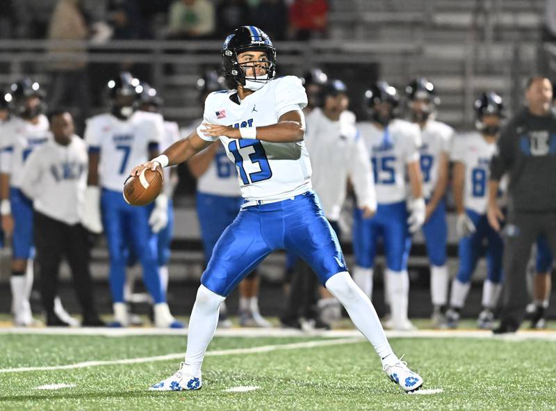 Lincoln-Way East quarterback Jonas Williams (13) throws a pass during a nonconference game against Andrew on Friday, Oct. 18, 2024, at Tinley Park.