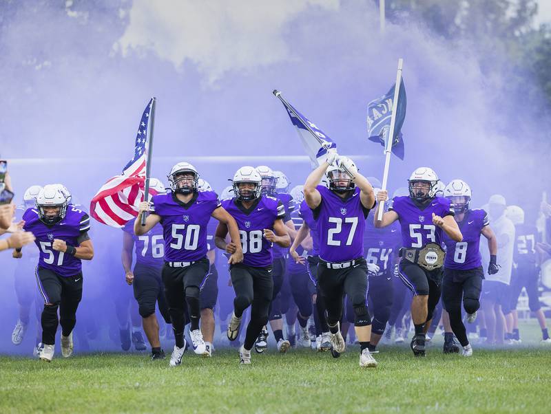 The Dixon Dukes football team crashes A.C. Bowers field in Dixon Friday, Aug. 30, 2024, to start the football season against Stillman Valley.