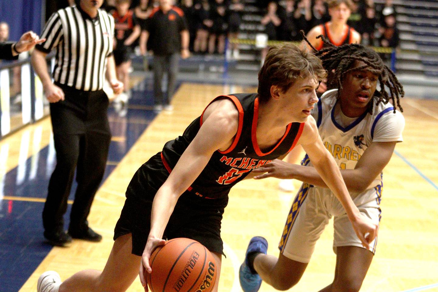 McHenry’s Caleb Jett, front, moves the ball as Warren’s Braylon Walker defends during IHSA Class 4A Sectional Final action at Rock Valley College on Friday night.