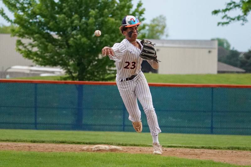 Oswego’s Kamrin Jenkins (23) turns a double play against Oswego East during a baseball game at Oswego High School on Monday, May 13, 2024.