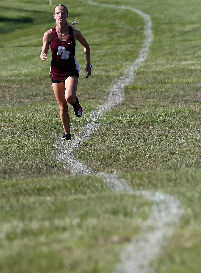 Prairie Ridge’s Rachel Soukup runs to the finish line girls race of the McHenry County Cross Country Meet Saturday, August 27, 2022, at Emricson Park in Woodstock.