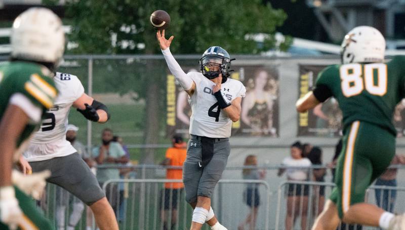 Oswego East's Niko Villacci (4) throws a pass against Waubonsie Valley during a football game at Waubonsie Valley High School in Aurora on Friday, Aug. 25, 2023.