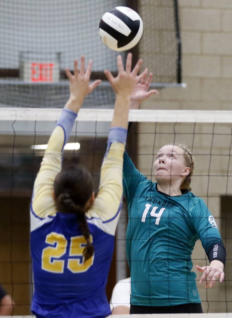 Woodstock North's Devynn Schulze hits the ball over the block of Johnsburg's Juliana Cashmore during a Kishwaukee River Conference volleyball match on Wednesday, Sept. 4, 2024, at Woodstock North High School.