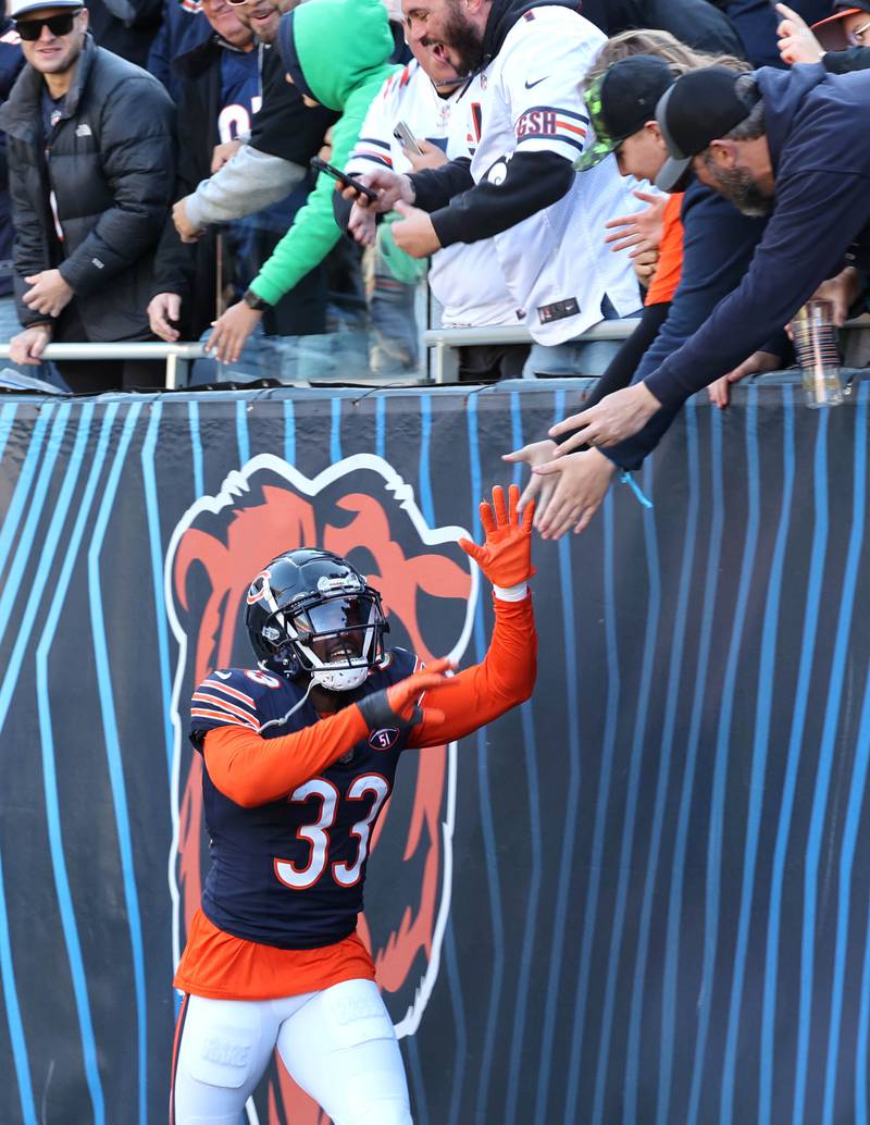 Chicago Bears cornerback Jaylon Johnson celebrates with fans as he comes off the field after his second interception during their game against the Las Vegas Raiders Sunday, Oct. 22, 2023, at Soldier Field in Chicago.