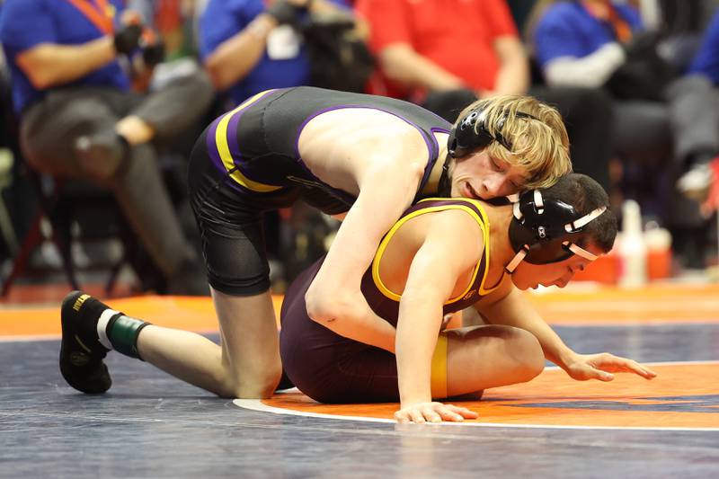 Wauconda’s Gavin Rockey works over Montini’s Allen Woo in the 106-pound Class 2A state championship match on Saturday, Feb. 17th, 2024 in Champaign.